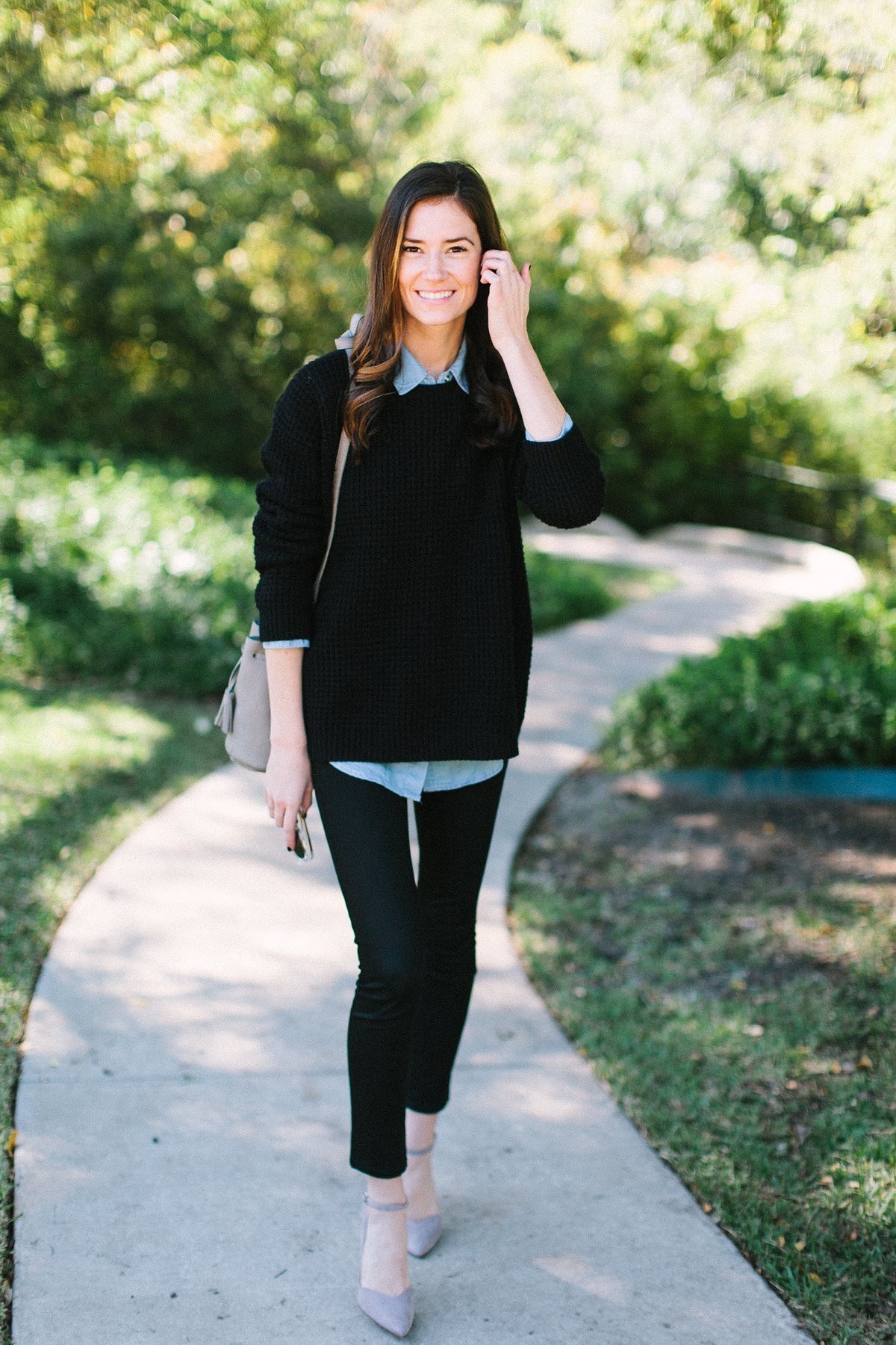 Black sweater layered over chambray shirt with grey accessories